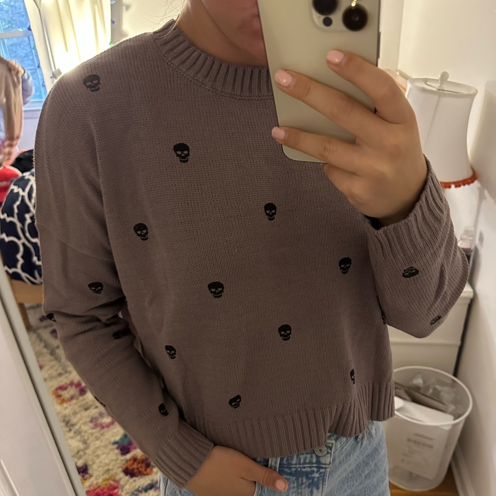 Super cute purple and black skull sweater. Size medium but fits like a small.